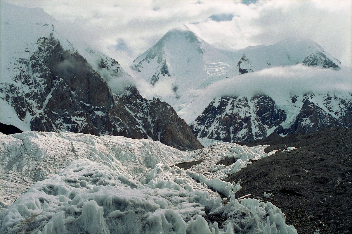 16 Gasherbrum I and Gasherbrum I South From Abruzzi Glacier The next morning we started our trek to Gasherbrum base camp in mostly cloudy weather. After 30 minutes we reached Gasherbrum Corner at the junction of the Upper Baltoro Glacier with the tributary Abruzzi Glacier. Gasherbrum I and Gasherbrum I South lie straight ahead. Gasherbrum I (8080m) is the 11th highest mountain in the world. Gasherbrum I was first climbed by July 5, 1958 by Americans Pete Schoening and Andy Kauffman.